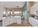 Bright kitchen featuring a large window with backyard view and white kitchen island at 42102 N Long Cove Way, Phoenix, AZ 85086
