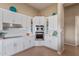 Well lit kitchen area featuring white cabinetry, tile floors and stainless steel appliances at 42102 N Long Cove Way, Phoenix, AZ 85086