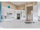 Modern kitchen boasts white cabinetry, stainless steel appliances, and quartz countertops at 42102 N Long Cove Way, Phoenix, AZ 85086