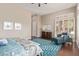 Well lit primary bedroom with sitting area, and a large window with plantation shutters at 42102 N Long Cove Way, Phoenix, AZ 85086