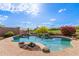 Inviting backyard pool surrounded by desert landscaping and featuring rock accents and clear blue water at 42102 N Long Cove Way, Phoenix, AZ 85086