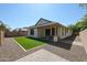 Backyard with a covered patio, artificial turf, and low-maintenance landscaping at 4336 E Mesquite St, Gilbert, AZ 85296