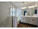 Bright bathroom featuring a double sink vanity, a soaking tub, and a glass enclosed walk in shower at 4336 E Mesquite St, Gilbert, AZ 85296