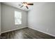 Comfortable bedroom with a ceiling fan, a window providing natural light, and attractive wood look flooring at 4336 E Mesquite St, Gilbert, AZ 85296