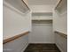 Walk-in closet featuring wood look floors with white walls, shelves, and wooden hanging racks at 4336 E Mesquite St, Gilbert, AZ 85296