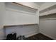 Spacious walk-in closet with dark wood floors, wooden racks, and white shelving to maximize storage at 4336 E Mesquite St, Gilbert, AZ 85296