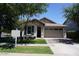 Charming single-story home featuring a well-manicured lawn, mature trees, and a two-car garage at 4336 E Mesquite St, Gilbert, AZ 85296
