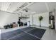 Spacious garage with epoxy flooring, storage racks, and ample room for parking at 4336 E Mesquite St, Gilbert, AZ 85296