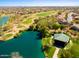 Aerial view of a Primary-planned community featuring a lake and golf course at 43914 W Wade Dr, Maricopa, AZ 85138