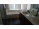 Bright bathroom featuring a large tub, a window and a double sink at 43914 W Wade Dr, Maricopa, AZ 85138