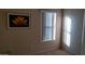 Clean bedroom featuring a framed art print and bright window at 43914 W Wade Dr, Maricopa, AZ 85138