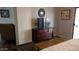 Cozy bedroom featuring a large dresser and access to a covered outdoor patio at 43914 W Wade Dr, Maricopa, AZ 85138