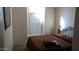 Comfortable bedroom with a queen bed, a window, and a dark-colored comforter at 43914 W Wade Dr, Maricopa, AZ 85138