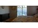 Bright bedroom featuring a sliding glass door with patio furniture outside and a dresser at 43914 W Wade Dr, Maricopa, AZ 85138