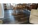 Dining area with wood-look flooring and an eat-in kitchen at 43914 W Wade Dr, Maricopa, AZ 85138