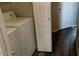 Laundry room with washer, dryer, and wood-look flooring at 43914 W Wade Dr, Maricopa, AZ 85138