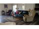 Spacious living room featuring hardwood floors, stylish sofas and a decorative area rug at 43914 W Wade Dr, Maricopa, AZ 85138