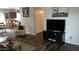 Modern living room showcases stylish decor with a large TV and wood-like flooring at 43914 W Wade Dr, Maricopa, AZ 85138