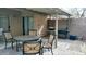 Cozy outdoor patio with a table and chairs, perfect for relaxing and entertaining guests at 43914 W Wade Dr, Maricopa, AZ 85138
