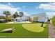 Modern home featuring a putting green, cornhole boards, pool and lush landscaping in the backyard at 4502 E Solano Dr, Phoenix, AZ 85018