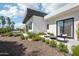 The backyard features a stone landscape design and patio with comfortable outdoor seating and desert landscaping at 4502 E Solano Dr, Phoenix, AZ 85018