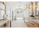 Luxurious bathroom featuring dual vanities, a soaking tub, and a separate make up vanity at 4502 E Solano Dr, Phoenix, AZ 85018