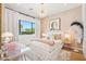 Charming bedroom with a chandelier, decor pillows, and a large window offering plenty of natural light at 4502 E Solano Dr, Phoenix, AZ 85018