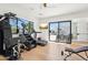 Spacious home gym with modern equipment, large windows offering natural light, and seamless access to the outdoor patio at 4502 E Solano Dr, Phoenix, AZ 85018