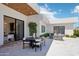 Elegant outdoor patio featuring a dining table, lounge seating, and seamless indoor-outdoor flow for comfortable entertaining at 4502 E Solano Dr, Phoenix, AZ 85018