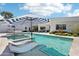 Luxury home showcasing a swimming pool with a spa, lounge chairs, and an outdoor kitchen and seating area at 4502 E Solano Dr, Phoenix, AZ 85018