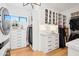 Bright walk-in closet with custom cabinetry, drawers, and closet rods for optimal storage and organization at 4502 E Solano Dr, Phoenix, AZ 85018