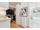 Well-organized walk-in closet leading into a bathroom with a soaking tub and elegant chandelier at 4502 E Solano Dr, Phoenix, AZ 85018