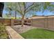 Charming backyard featuring decorative rocks, mature trees, and artificial turf, creating a serene outdoor space at 4840 E Sunnyside Dr, Scottsdale, AZ 85254