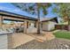 Spacious backyard featuring an outdoor kitchen, covered patio, swimming pool, and beautifully landscaped areas at 4840 E Sunnyside Dr, Scottsdale, AZ 85254