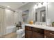 Cozy bathroom with a shower-tub combo, tile surround, vanity with ample storage, and neutral decor at 4840 E Sunnyside Dr, Scottsdale, AZ 85254