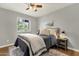 Well-lit bedroom features a comfortable bed, side table with a lamp, and a window providing natural light at 4840 E Sunnyside Dr, Scottsdale, AZ 85254