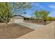Inviting single-Gathering home features a spacious driveway, attached garage, and low-maintenance desert landscaping at 4840 E Sunnyside Dr, Scottsdale, AZ 85254