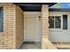 Stylish front entry with a decorative door, brick accents, and a charming outdoor light fixture at 4840 E Sunnyside Dr, Scottsdale, AZ 85254