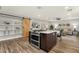 Open-concept kitchen island is equipped with a range and oven, white countertops, and is adjacent to the living room at 4840 E Sunnyside Dr, Scottsdale, AZ 85254