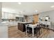 Bright eat-in kitchen features a large island with white countertops and adjacent dining space with an eye-catching sliding barn door at 4840 E Sunnyside Dr, Scottsdale, AZ 85254