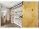 Walk-in pantry featuring a pair of sliding barn doors and shelving; plenty of space for storage and organization at 4840 E Sunnyside Dr, Scottsdale, AZ 85254