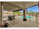 Covered patio with seating overlooking a fenced in pool area and attractive landscaping; a perfect outdoor oasis at 4840 E Sunnyside Dr, Scottsdale, AZ 85254