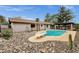 Backyard pool area, complete with a diving board, pergola, rock garden, and covered patio at 4840 E Sunnyside Dr, Scottsdale, AZ 85254