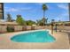 Sparkling in-ground pool surrounded by lush landscaping and a spacious patio area; creating a private retreat at 4840 E Sunnyside Dr, Scottsdale, AZ 85254