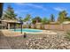 Refreshing in-ground pool with rock landscaping, diving board and covered pergola at 4840 E Sunnyside Dr, Scottsdale, AZ 85254