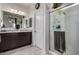Bathroom with double vanity, dark wood cabinets, and a glass-enclosed shower at 5146 E Diatomite Dr, San Tan Valley, AZ 85143