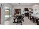 Bright dining area with a wooden table, bench, and sliding glass door leading to the backyard at 5146 E Diatomite Dr, San Tan Valley, AZ 85143
