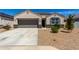 Inviting home featuring a well-manicured front yard and a convenient two-car garage at 5146 E Diatomite Dr, San Tan Valley, AZ 85143