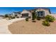Exterior view of a lovely home featuring desert landscaping with plants and a spacious driveway at 5146 E Diatomite Dr, San Tan Valley, AZ 85143