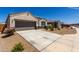 Attractive home with a long driveway, desert landscaping, and a charming front entrance at 5146 E Diatomite Dr, San Tan Valley, AZ 85143